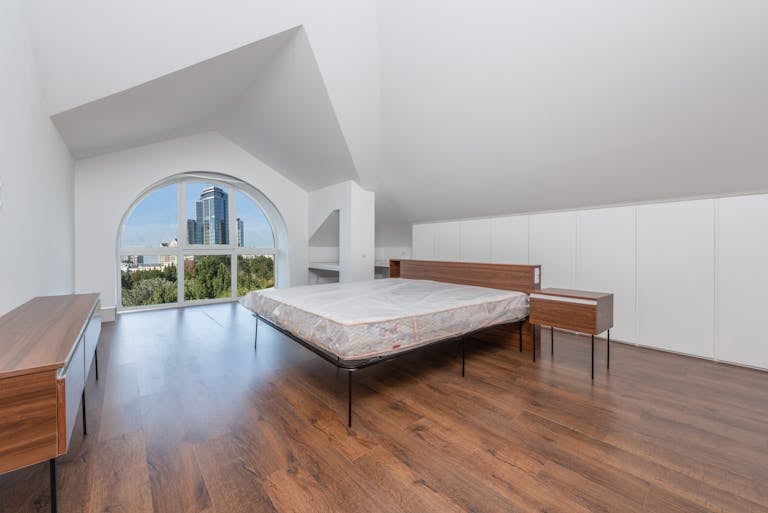 A White Bed inside a Bedroom